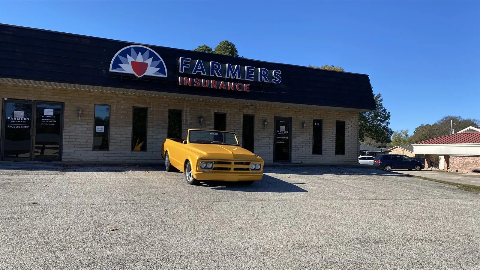 Vintage yellow truck parked in front of Pace Insurance Agency in Longview, Texas